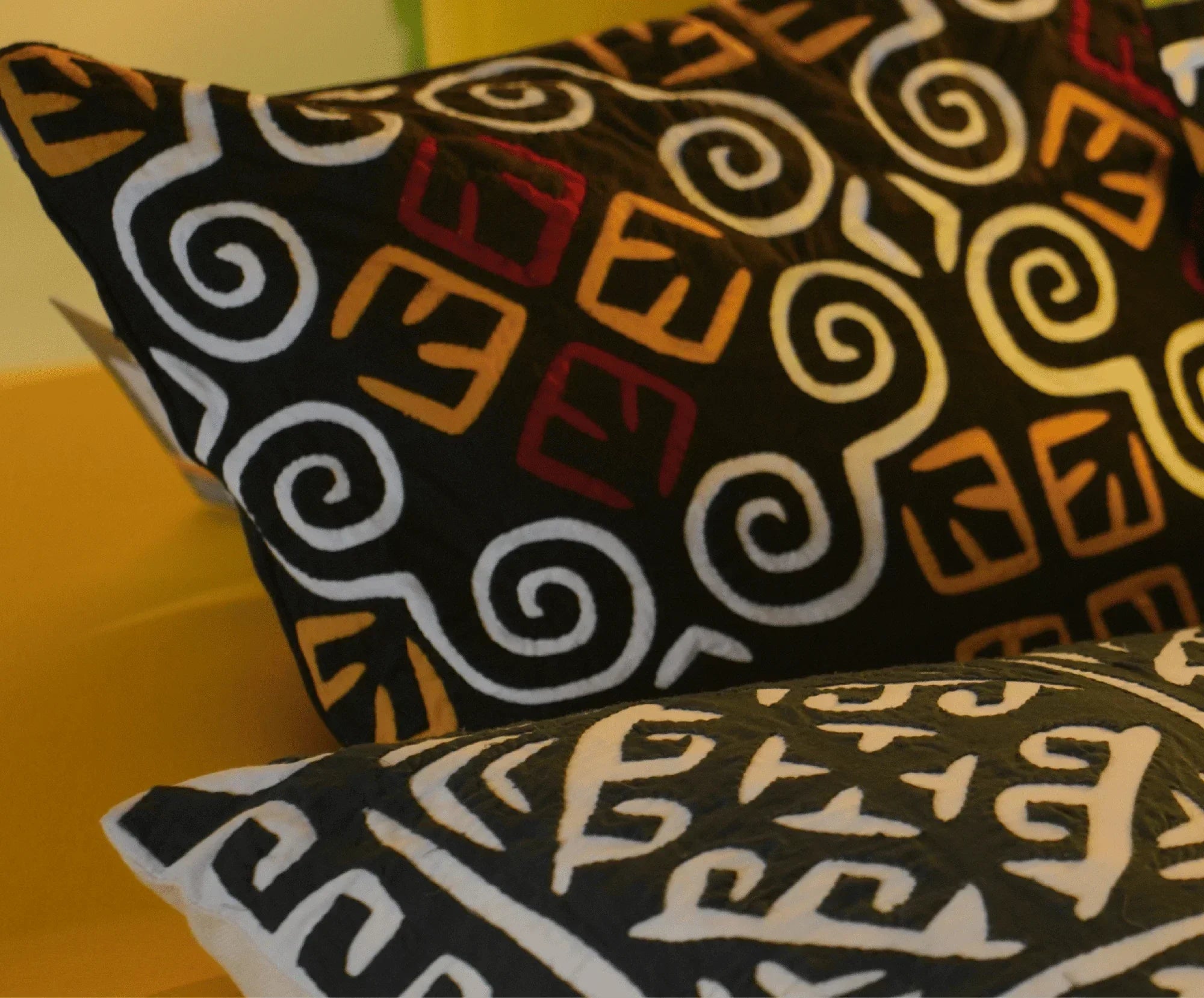 Handcrafted decorative cushion covers with bold geometric and swirl patterns, artisan style