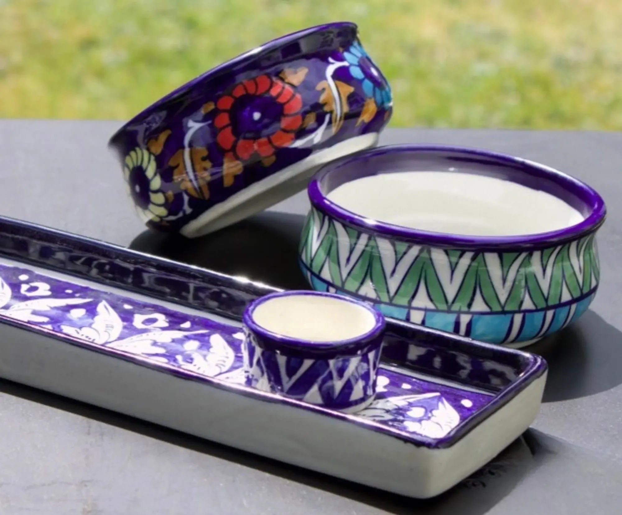Handcrafted Pakistani ceramic bowls and trays with vibrant blue, floral, and geometric patterns