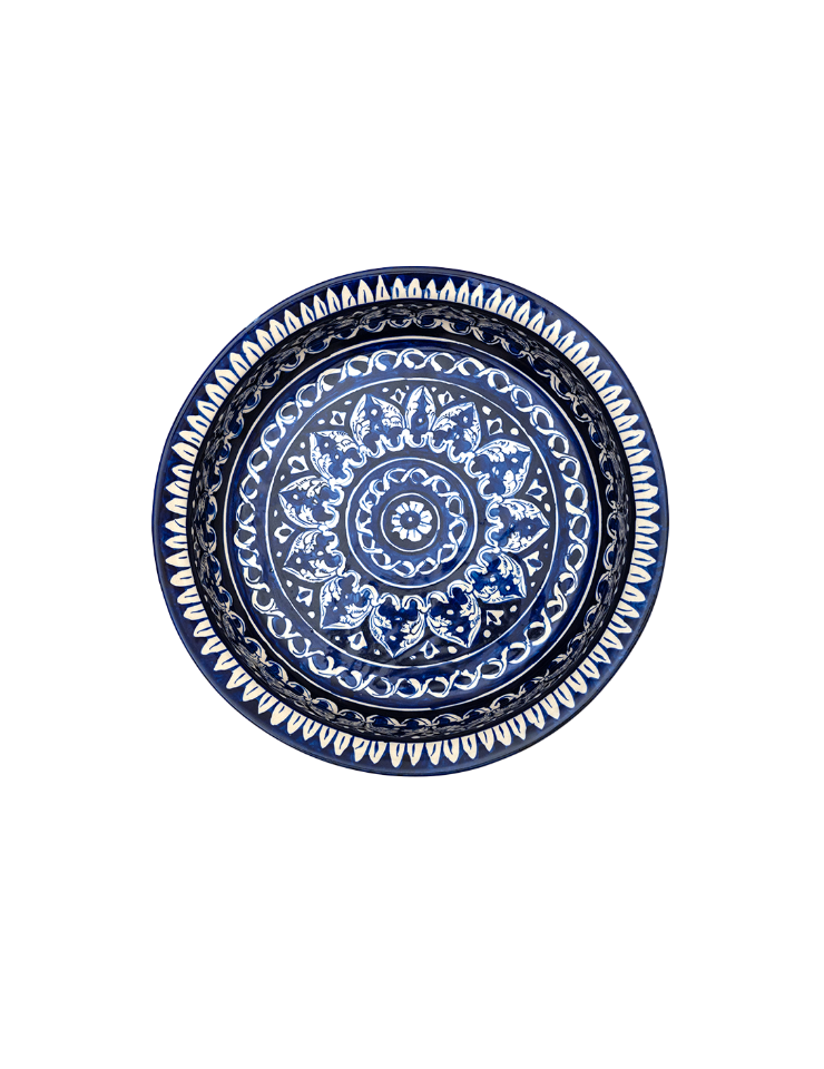 Decorative plate with blue and white mandala design on a white background
